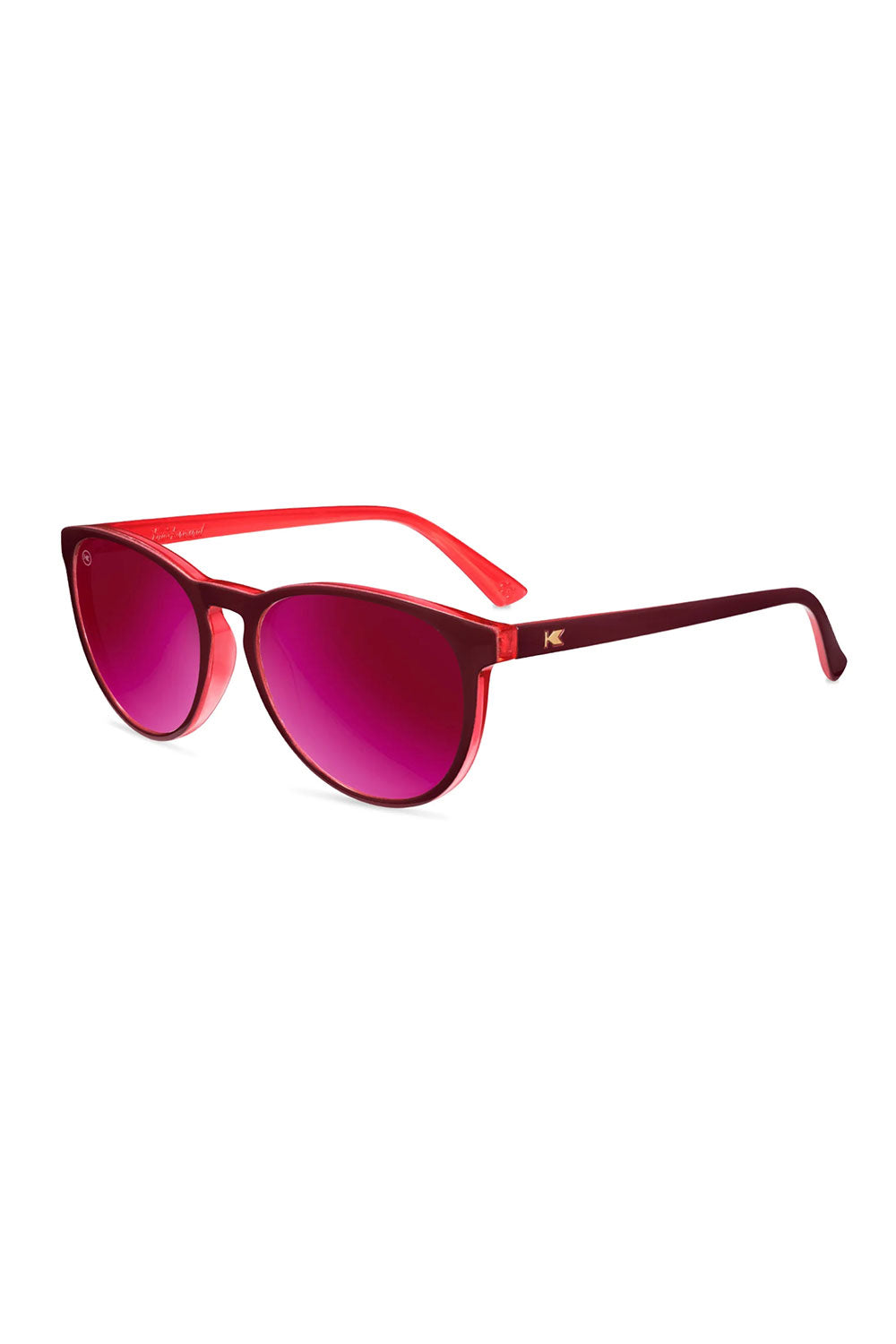 Red sunglasses with pink lenses on a white background