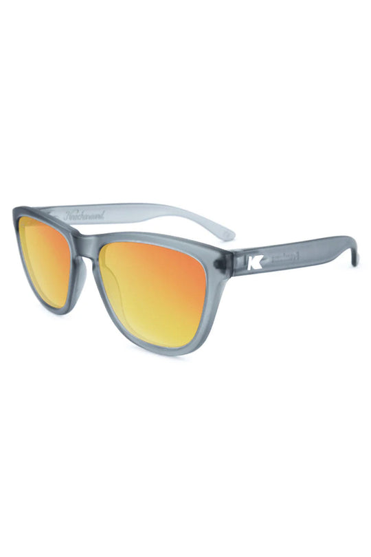 Sunglasses with orange lenses and gray frame on a white background