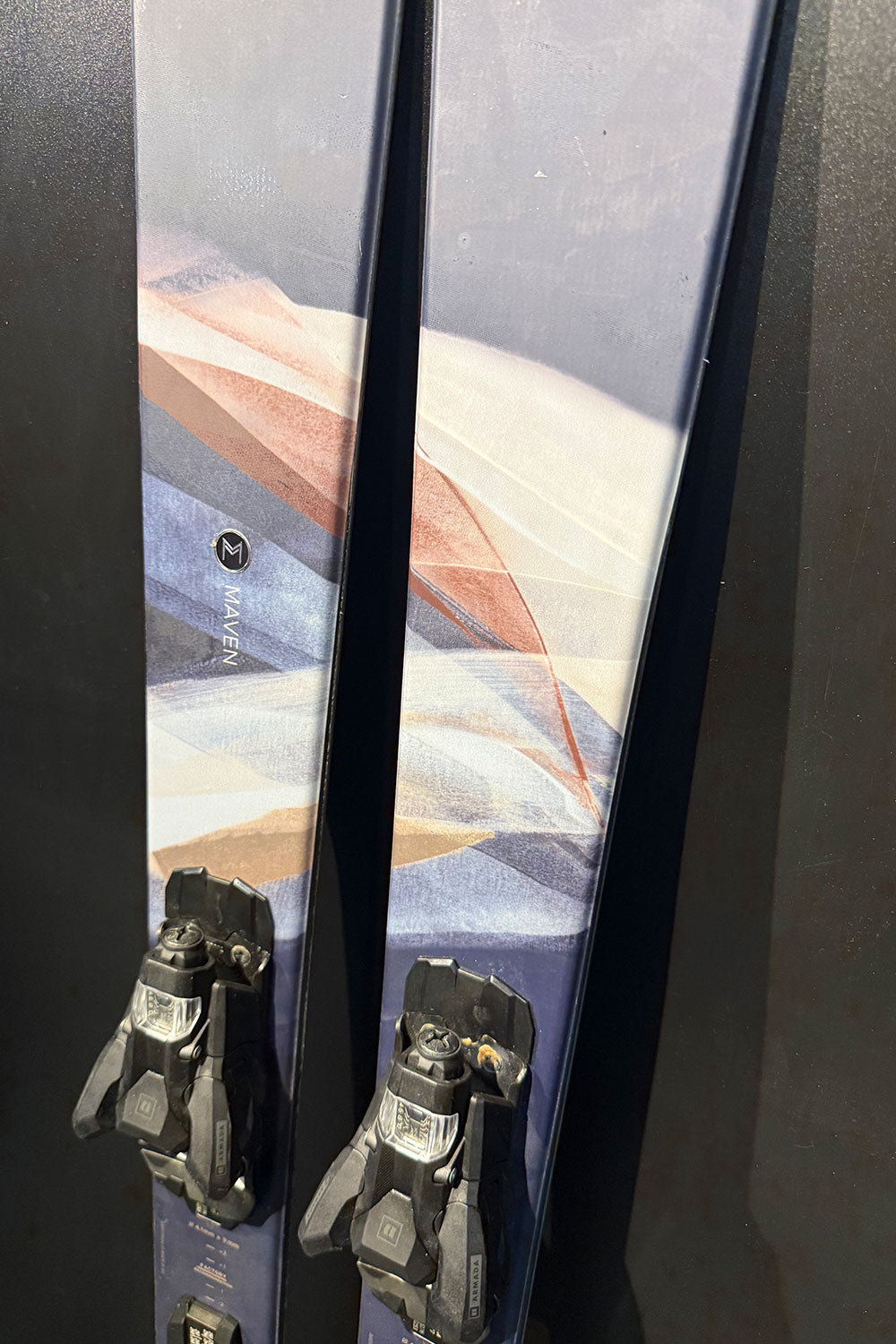 Pair of skis with bindings on a dark background
