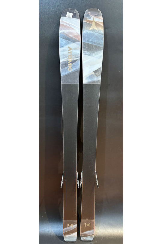 Two skis with a brand logo on a reflective surface