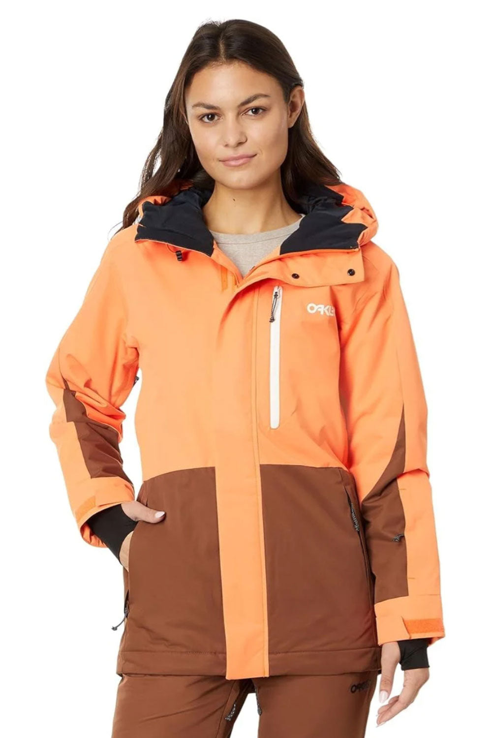 Person wearing an orange and brown jacket with a visible brand logo on a white background