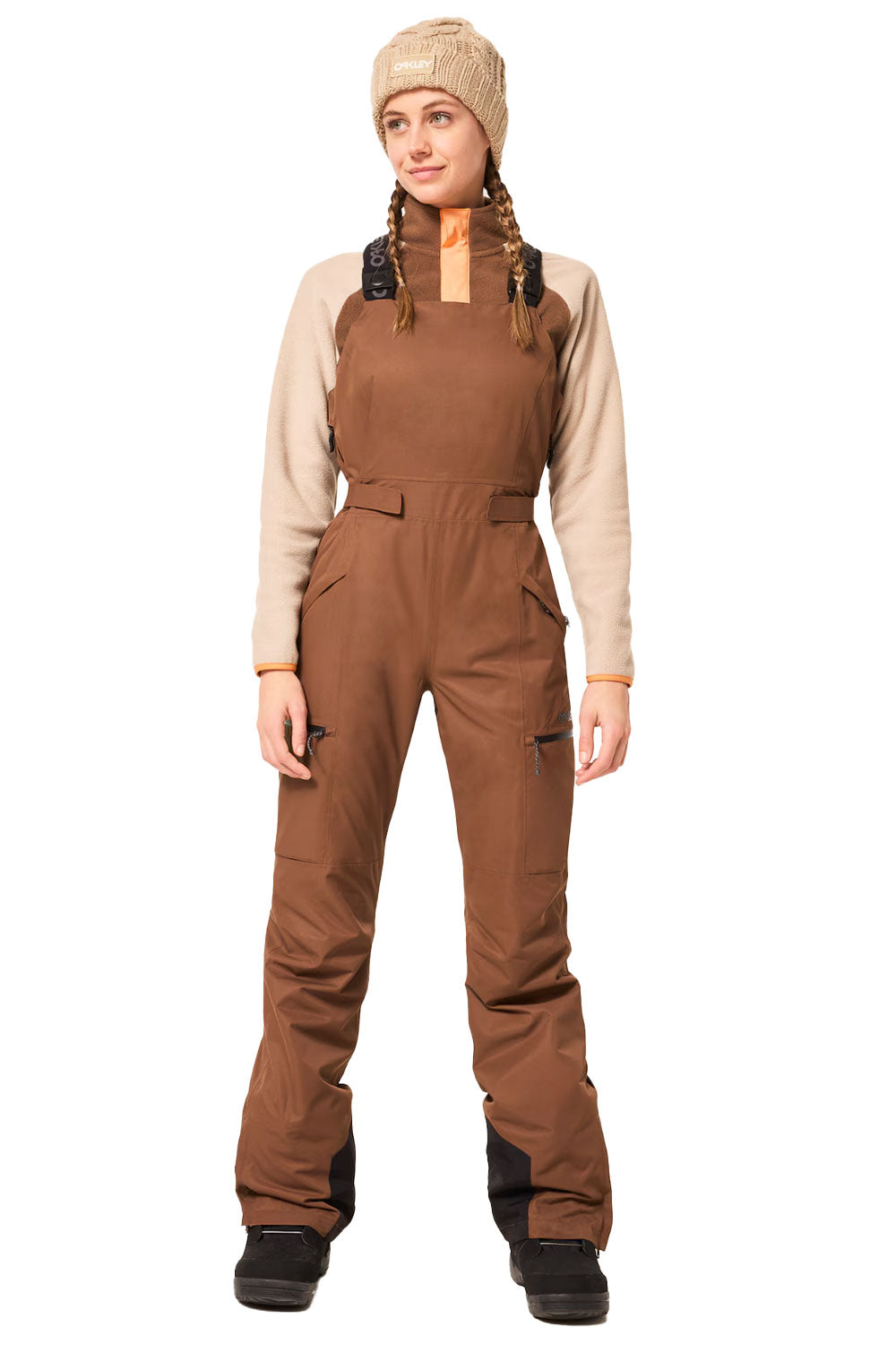 Person wearing a brown snowsuit with a beige shirt underneath on a white background
