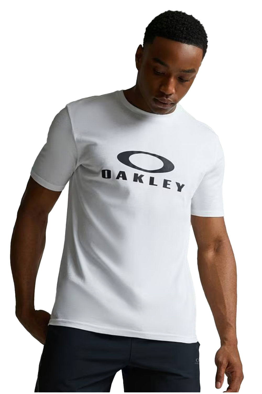Man wearing a white Oakley t-shirt on a white background