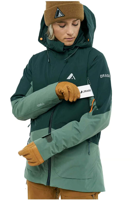 Person wearing a green and gray jacket with a brand logo on a white background