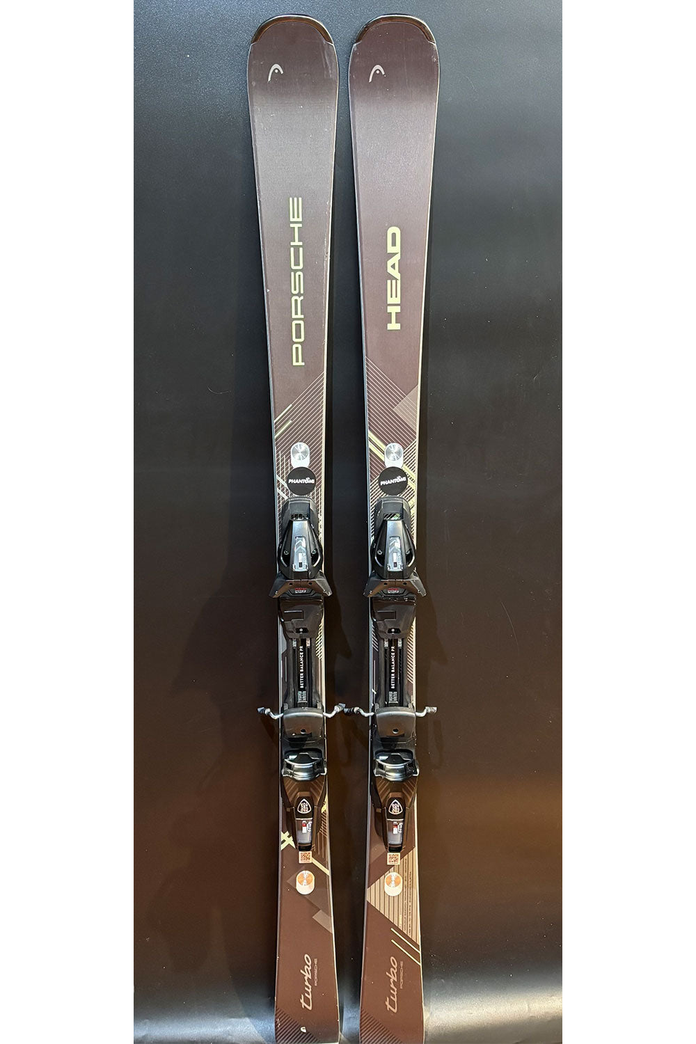 Pair of skis with bindings on a reflective surface