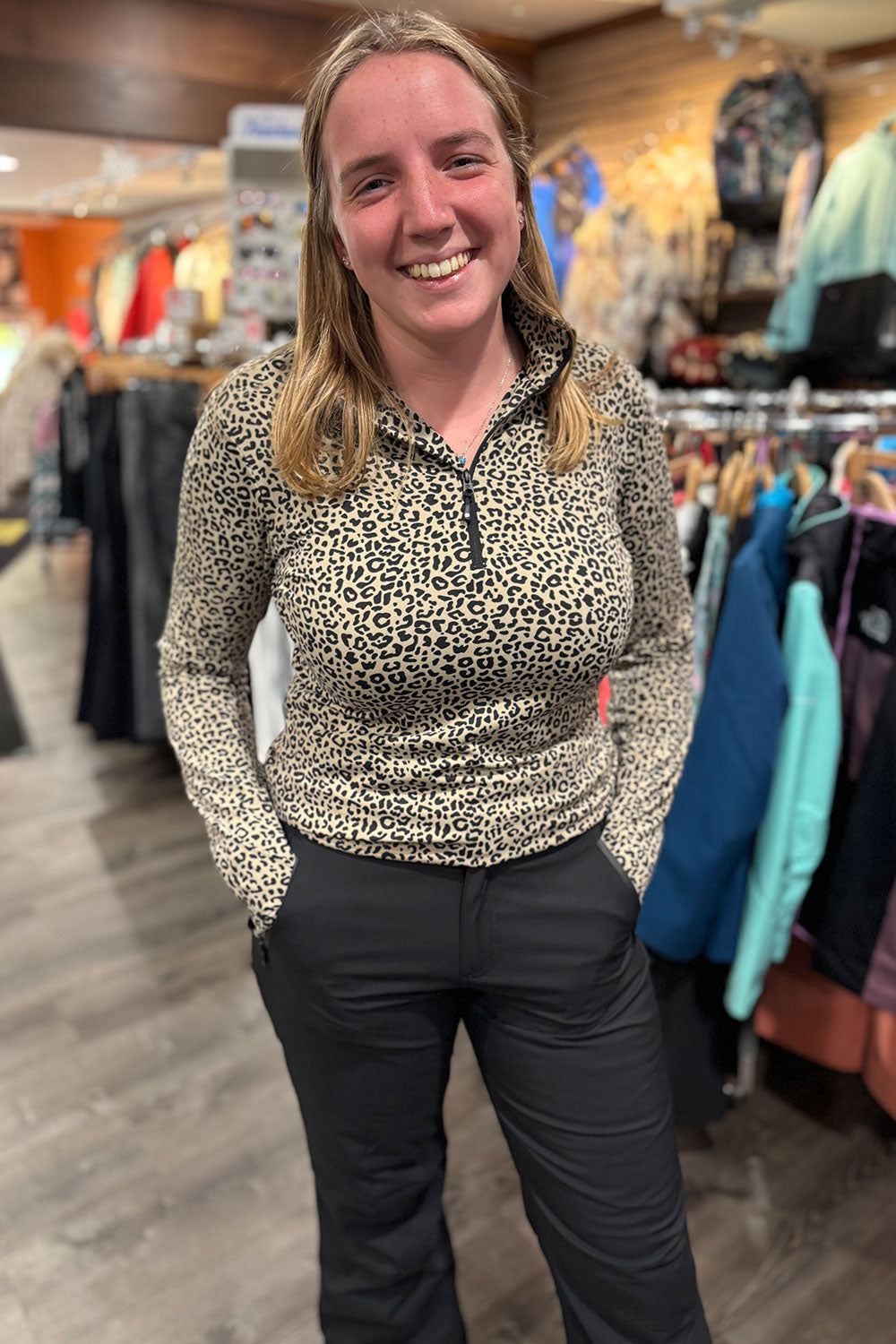 Woman wearing a leopard print top in a store setting