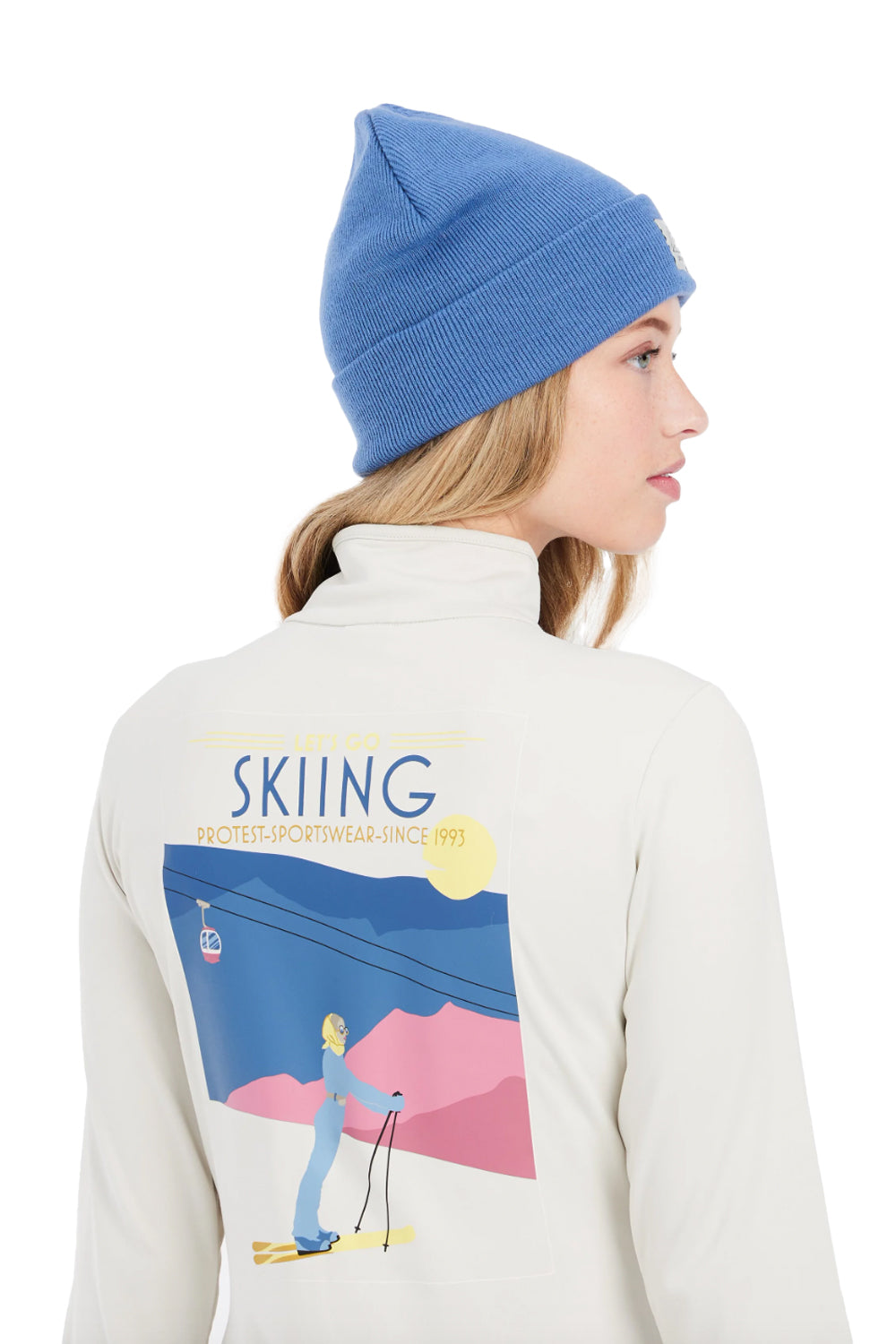 women's Protest Lunar 1/4 zip midlayer top, off white, with Let's go Skiing skier graphic on back