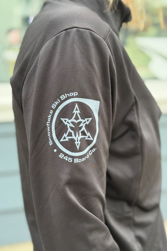 Dark jacket with a logo on the back, featuring text and a star design.