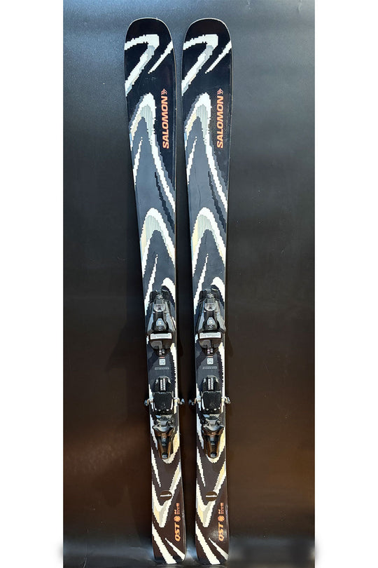 Pair of Salomon skis with bindings on a dark background