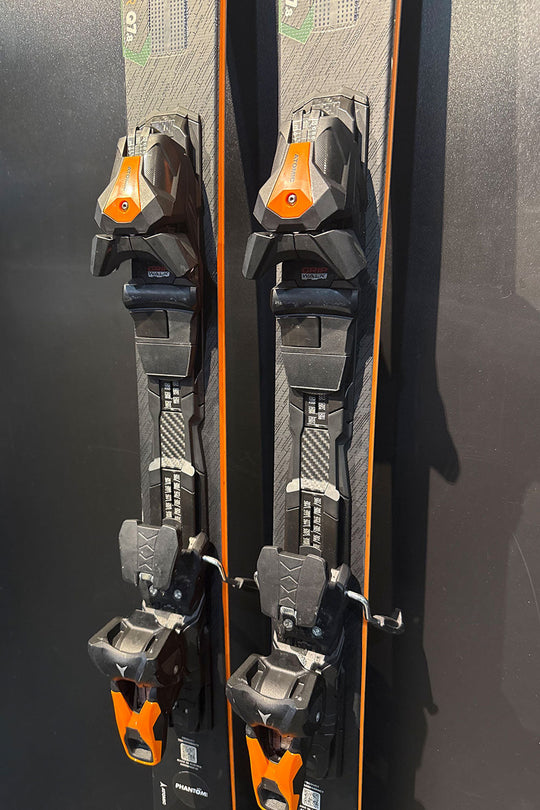 Pair of skis with bindings on a dark background