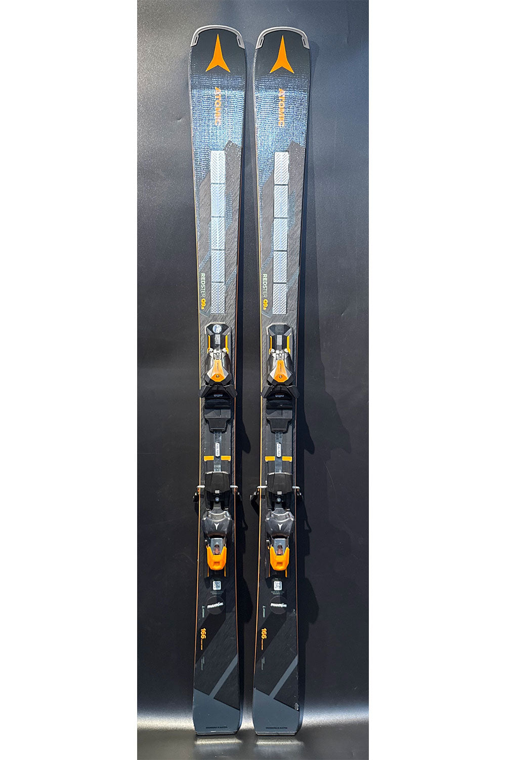 Two skis with bindings on a black background