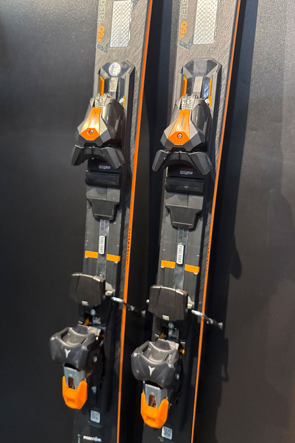 Two skis with bindings against a black background