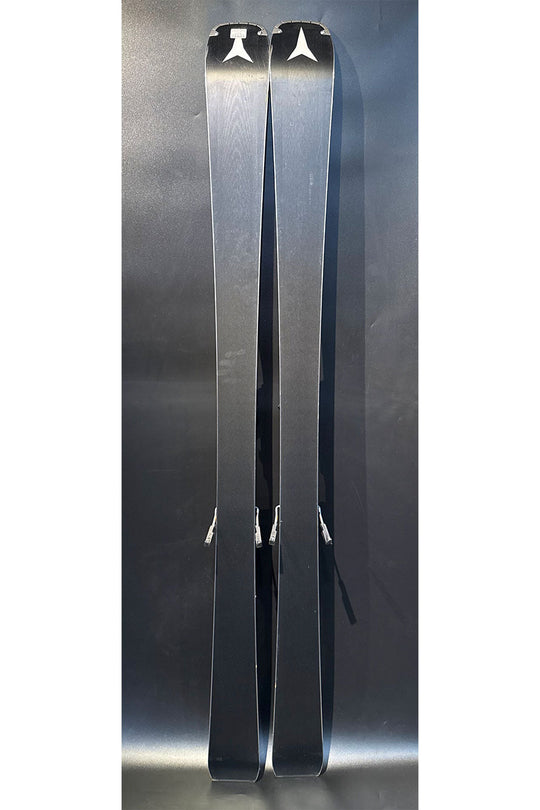 Pair of skis with visible branding on a reflective surface