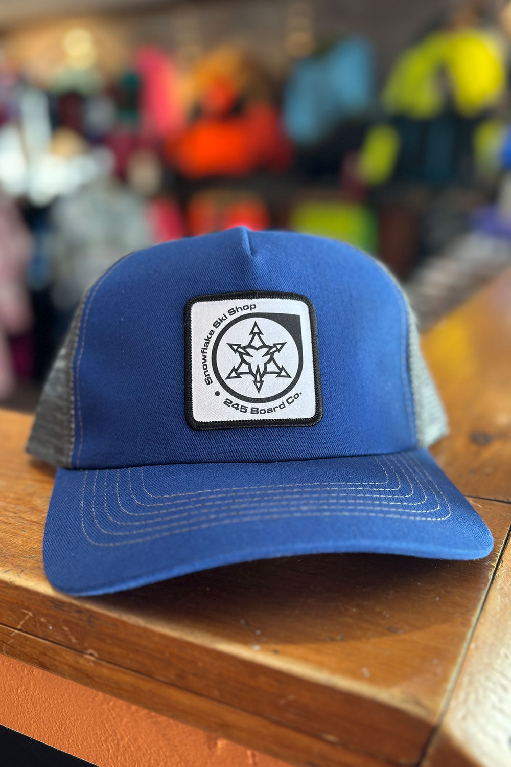 Blue cap with a logo on a wooden surface with a blurred background