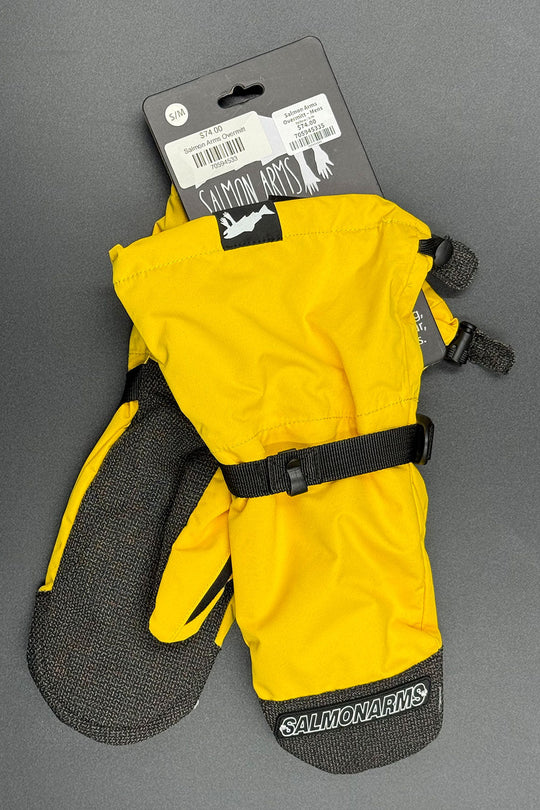 Yellow and black Salmon Arms ski mittens on a gray background