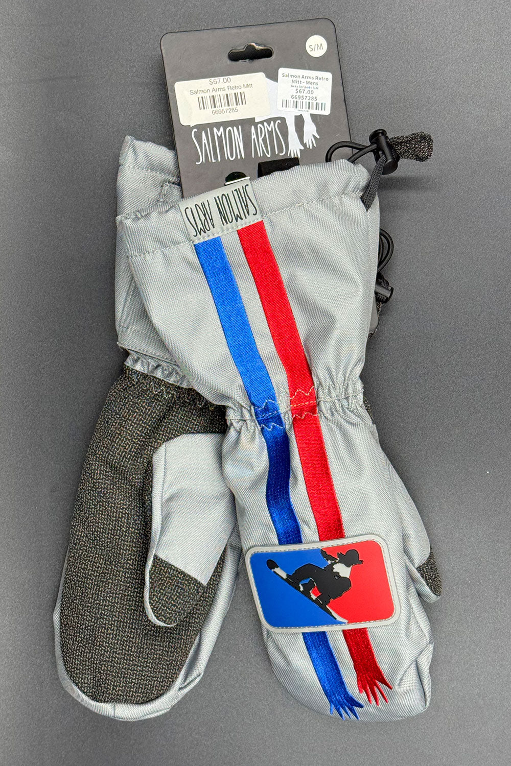 Gray mittens with red, blue, and white stripes on a gray background