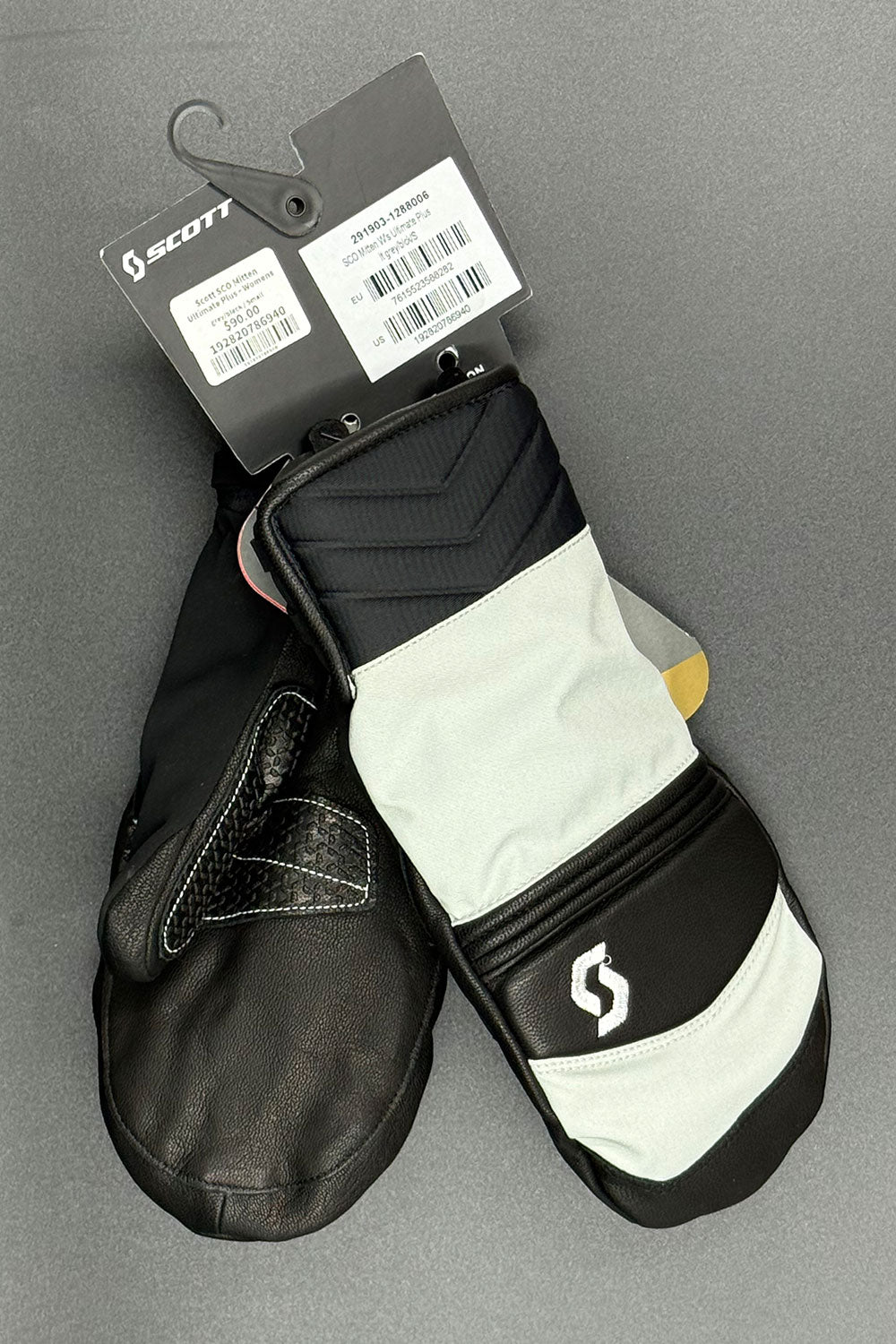 Black and white mitten with Scott branding on a gray background