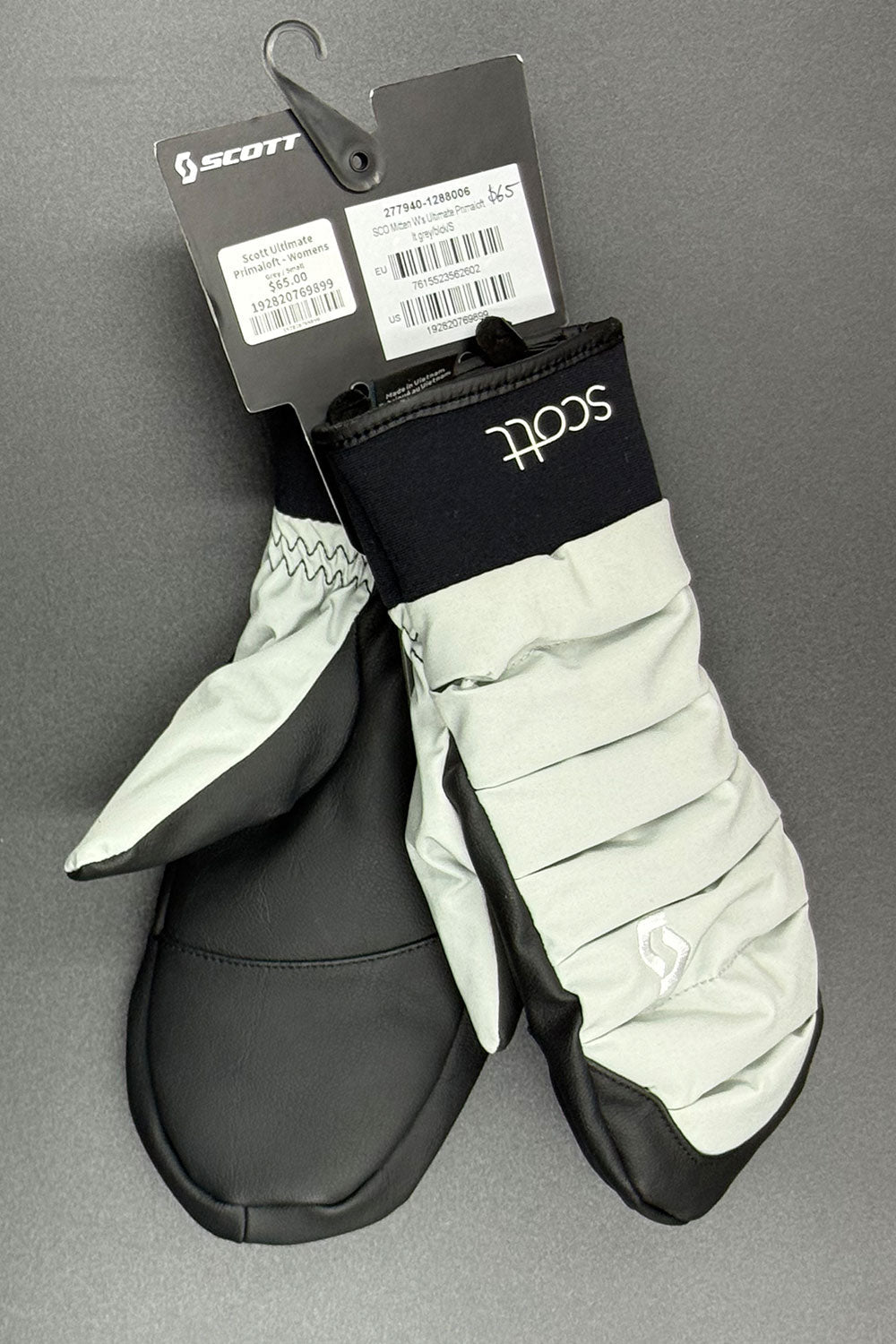 Pair of Scott mittens with tags on a gray background