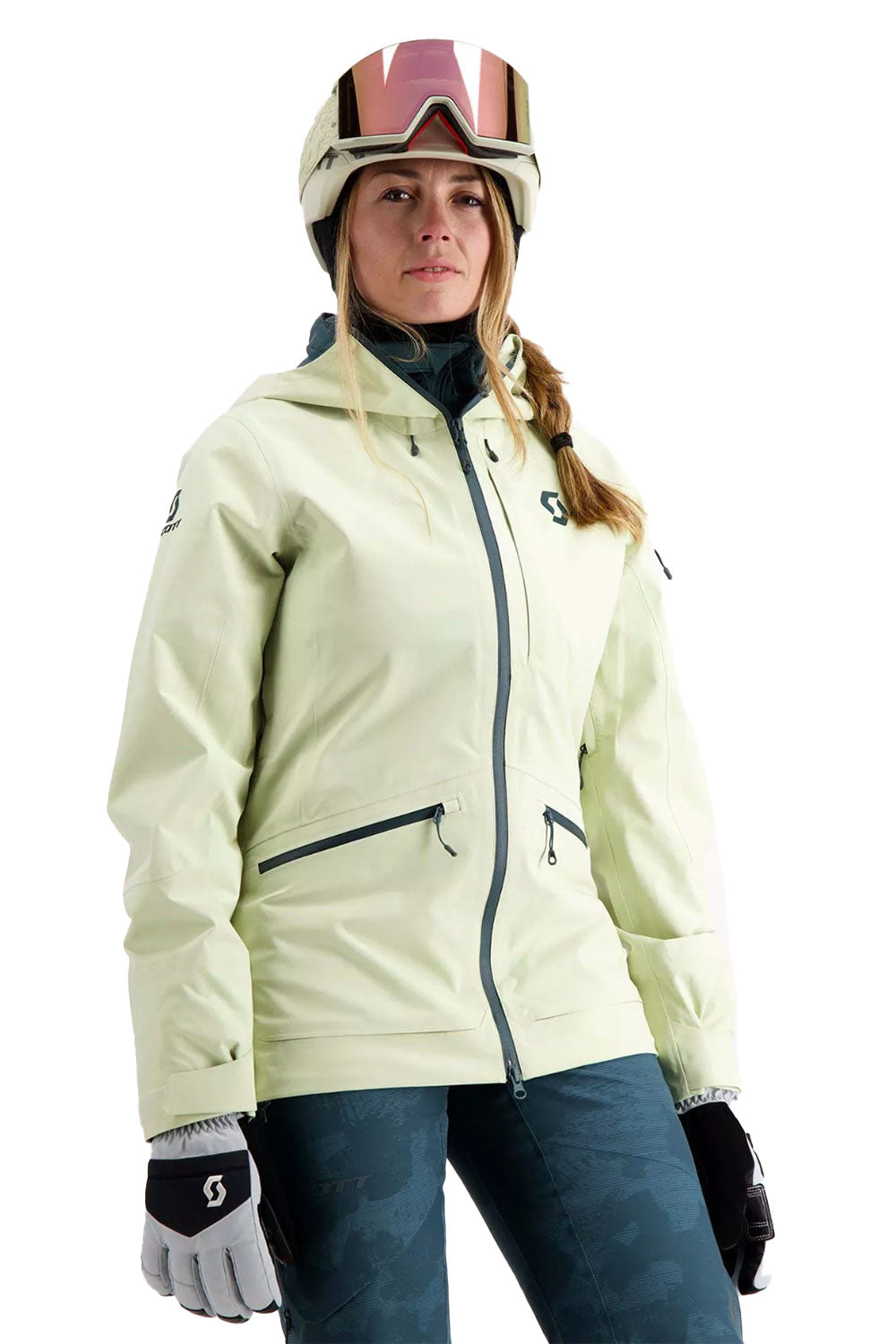 Person wearing a light-colored ski jacket, helmet, and goggles on a white background