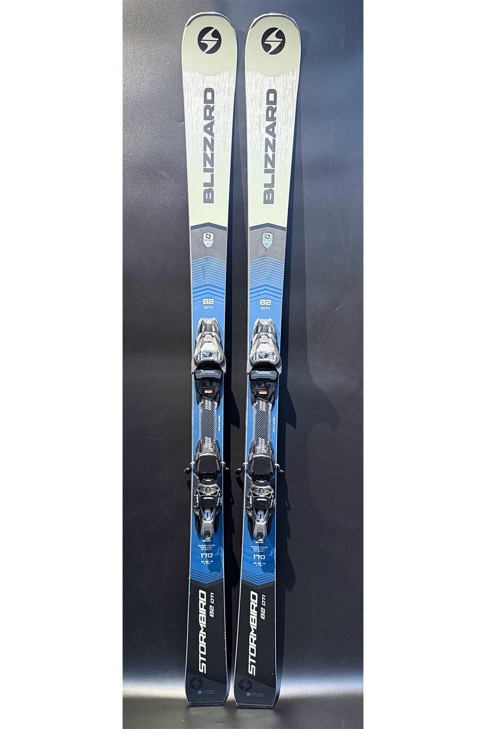 Pair of Blizzard skis with bindings on a dark background