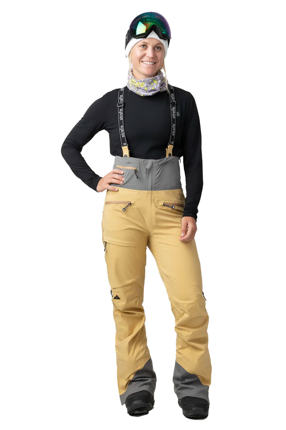 Person wearing a black top, tan pants, and a beanie with goggles on a white background