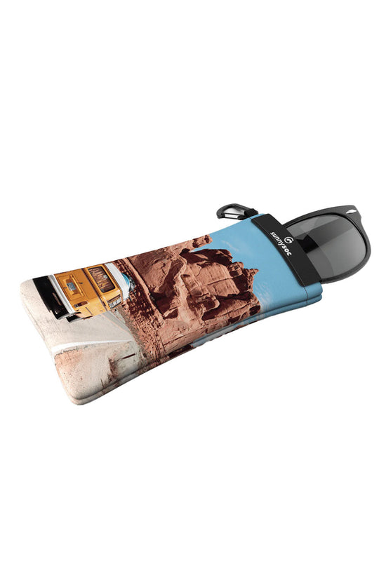 Sunglasses with a case featuring architectural designs on a white background