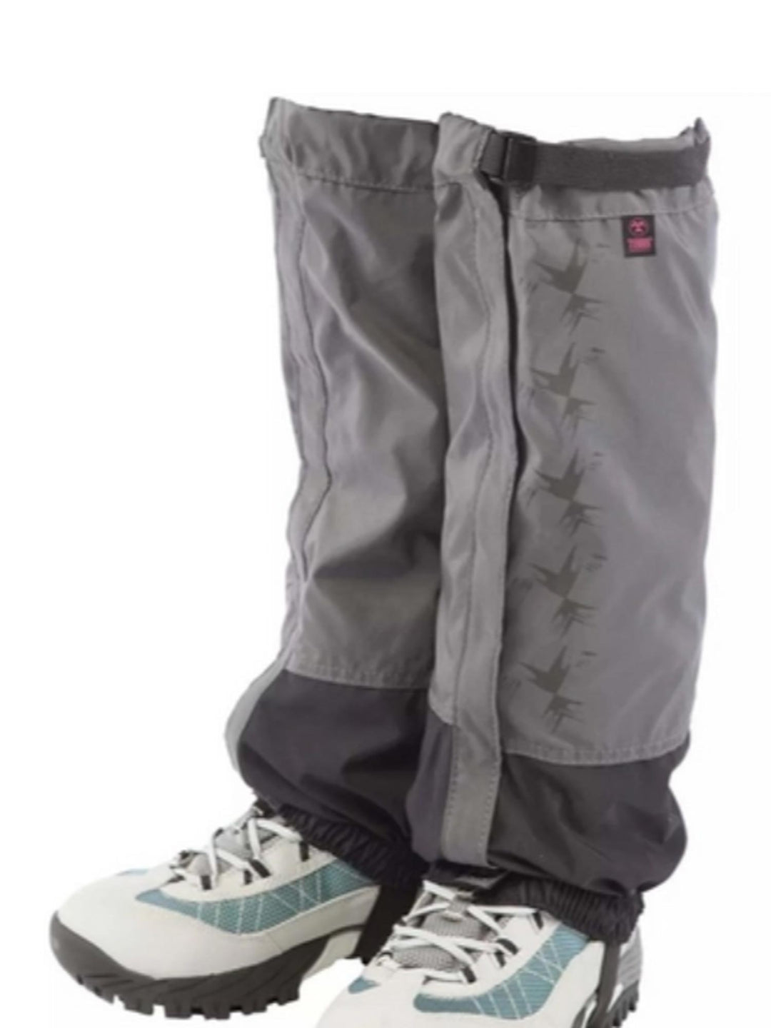 Gray gaiters worn over hiking boots on a white background