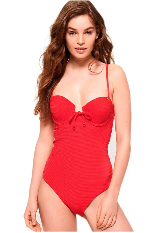 Woman wearing a red swimsuit on a white background